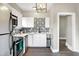 Stylish kitchen with white cabinets, black accents, and view to an adjacent room at 529 W 42Nd St, Indianapolis, IN 46208