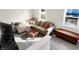 Bright living room with corner sectional couch, wood floors, and many windows at 529 W 42Nd St, Indianapolis, IN 46208