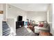 Spacious living room features a large couch, entertainment center, and stairs to the second floor at 529 W 42Nd St, Indianapolis, IN 46208