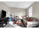 Cozy living room featuring a plush sectional couch, flat screen tv, and exercise bike at 529 W 42Nd St, Indianapolis, IN 46208