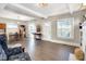 Open living room with hardwood floors, a decorative fireplace, and a dining area, perfect for entertaining guests at 529 W 42Nd St, Indianapolis, IN 46208