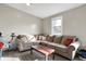 Cozy living room with a large sectional couch, wood floors, and a bright window at 529 W 42Nd St, Indianapolis, IN 46208