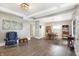 Bright and airy living space with hardwood floors, a dining area, and a cozy armchair creating a welcoming ambiance at 529 W 42Nd St, Indianapolis, IN 46208