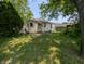 View of the house's rear showcasing a cozy yard and traditional siding at 603 W 33Rd St, Anderson, IN 46013