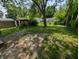 Lush backyard featuring a storage shed and mature trees, offering a private outdoor space at 603 W 33Rd St, Anderson, IN 46013
