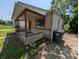 Low angle from side and front view of the home with stone and siding exterior and a shaded front porch at 603 W 33Rd St, Anderson, IN 46013