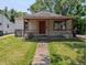 Charming bungalow-style house with a red front door and covered front porch at 603 W 33Rd St, Anderson, IN 46013