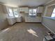 Kitchen featuring white cabinets, neutral countertops, double sink, and tile flooring at 603 W 33Rd St, Anderson, IN 46013