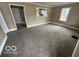 Spacious living room featuring view to the kitchen, neutral carpet and ample light at 603 W 33Rd St, Anderson, IN 46013