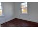 Bedroom featuring hardwood floors and natural light from two windows at 605 W 10Th St, Muncie, IN 47302