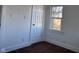 This bedroom features a door to another room and a bright window at 605 W 10Th St, Muncie, IN 47302