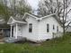 Cozy white house featuring well-maintained siding and a welcoming covered porch at 605 W 10Th St, Muncie, IN 47302