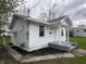 Charming white home featuring clean lines, a functional layout, and small side yard at 605 W 10Th St, Muncie, IN 47302