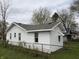 White-sided home with a neatly maintained roof, showcasing functional windows and fencing at 605 W 10Th St, Muncie, IN 47302