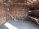 Interior view of the garage, revealing wood and concrete, offering versatile space for projects and storage at 605 W 10Th St, Muncie, IN 47302
