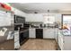 Bright kitchen with ample counter space, stainless steel appliances, and white cabinets at 6116 Bartley Ct, Indianapolis, IN 46236