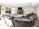 Comfortable living room featuring a fireplace, black leather sofas, and bright natural light at 6116 Bartley Ct, Indianapolis, IN 46236