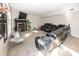 Cozy living room featuring a fireplace, black leather sofas, and carpet floors at 6116 Bartley Ct, Indianapolis, IN 46236