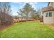 Backyard view, with a lawn area and a glimpse of the rear of the house and deck at 685 Greystone Ct, Columbus, IN 47201