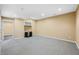 A finished basement room featuring a built-in cabinet, neutral carpet, and recessed lights at 685 Greystone Ct, Columbus, IN 47201