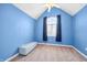 Bedroom features blue walls, carpeted floor, and natural light from a large window at 685 Greystone Ct, Columbus, IN 47201