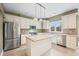 Bright kitchen with stainless steel appliances, a kitchen island, and tile flooring at 685 Greystone Ct, Columbus, IN 47201