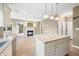 Bright, open kitchen featuring an island with granite countertops and a stainless steel dishwasher at 685 Greystone Ct, Columbus, IN 47201