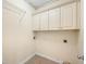 Functional laundry room with upper cabinets and tile flooring at 685 Greystone Ct, Columbus, IN 47201