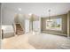 Bright, spacious living room with staircase, and large windows at 685 Greystone Ct, Columbus, IN 47201