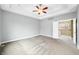 Large primary bedroom with a tray ceiling and a view to the upstairs hall at 685 Greystone Ct, Columbus, IN 47201