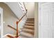 Carpeted staircase featuring a wooden handrail and white spindles at 685 Greystone Ct, Columbus, IN 47201