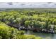 Expansive aerial view of lakefront properties surrounded by lush trees, highlighting the serene and private setting at 7082 Muskrat Dr, Nineveh, IN 46164