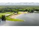 Breathtaking aerial view of a private beach, lake, green trees, and beach front parking at 7082 Muskrat Dr, Nineveh, IN 46164