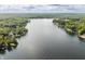 Picturesque aerial view of a tranquil lake, surrounded by lush forests and dotted with lakeside homes at 7082 Muskrat Dr, Nineveh, IN 46164