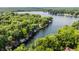 Scenic aerial view of homes along a tree-lined lake showcasing docks and waterfront living at 7082 Muskrat Dr, Nineveh, IN 46164