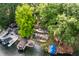 Stunning aerial view of lake home with multi-tiered decks, lush trees, and docks on the tranquil water at 7082 Muskrat Dr, Nineveh, IN 46164