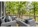 Back deck furnished with modern furniture, ideal for outdoor relaxation and entertaining at 7082 Muskrat Dr, Nineveh, IN 46164