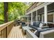 Spacious deck complete with modern furniture, a grill, and views of surrounding trees at 7082 Muskrat Dr, Nineveh, IN 46164