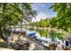 Scenic backyard with an outdoor dining area and a private dock on a serene lake at 7082 Muskrat Dr, Nineveh, IN 46164
