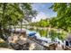 Scenic backyard with an outdoor dining area and a private dock on a serene lake at 7082 Muskrat Dr, Nineveh, IN 46164
