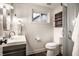 Small, bright bathroom featuring white toilet, cabinet sink, and glass shower at 7082 Muskrat Dr, Nineveh, IN 46164