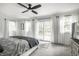 Bright bedroom with sliding door access to a wooden deck, natural light, and ceiling fan at 7082 Muskrat Dr, Nineveh, IN 46164