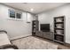 Basement living area with media center, storage baskets, and a small window for natural light at 7082 Muskrat Dr, Nineveh, IN 46164