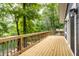 Wide wooden deck overlooking serene lake and green forest, great for enjoying nature at 7082 Muskrat Dr, Nineveh, IN 46164