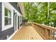 A spacious wooden deck with grey siding and lush trees, great for outdoor relaxing at 7082 Muskrat Dr, Nineveh, IN 46164