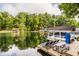 Lakeside view from a wooden dock featuring lounge chairs and a picnic table at 7082 Muskrat Dr, Nineveh, IN 46164