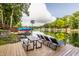 Lakeside view from a wooden dock featuring lounge chairs and a picnic table at 7082 Muskrat Dr, Nineveh, IN 46164