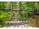 Exterior view of multiple homes with extensive decking and stairs leading to outdoor living spaces at 7082 Muskrat Dr, Nineveh, IN 46164