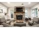 Comfortable living room featuring a stone fireplace, large windows, and stylish decor at 7082 Muskrat Dr, Nineveh, IN 46164