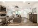 Cozy living room featuring a stone fireplace, plush seating, and sliding glass doors to the deck at 7082 Muskrat Dr, Nineveh, IN 46164